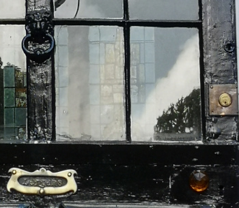 Black door with windows through to rear door