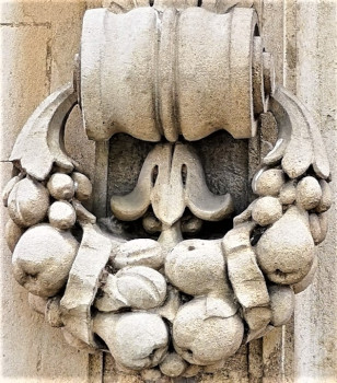 stone carved into wreath of fruits